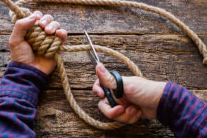 man cut the rope with a slipknot concept stop suicide